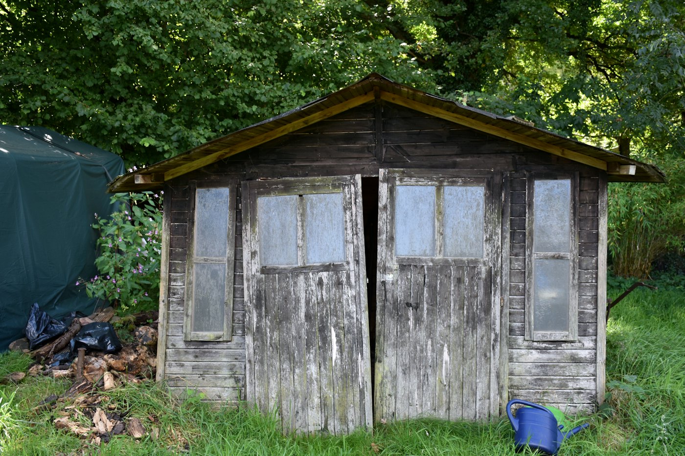 Before: old weathered wooden shed