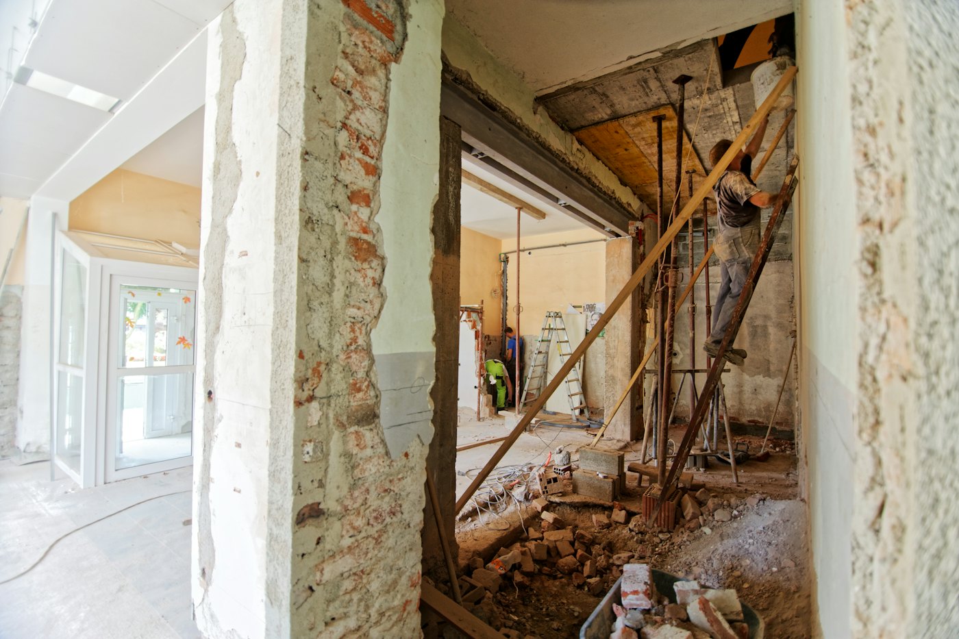 Before: damaged interior with broken walls and debris